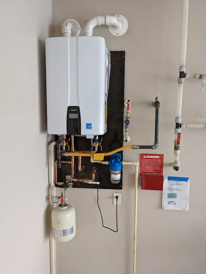 Professional plumber installing copper piping in a Marvin home
